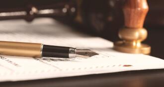 Law notary fountain pen and paper on desk
