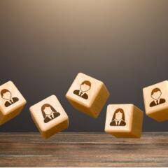 Levitating blocks with employees on a dark background