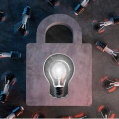 Lit lightbulb with fingerprint inside blub as the keyhole for padlock