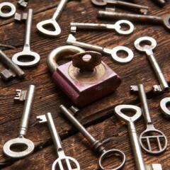 arrangement of old fashioned keys surrounding one old lock