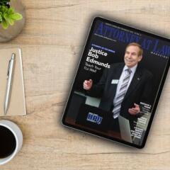 Ipad with magazine cover sitting on desk with coffee and notebook