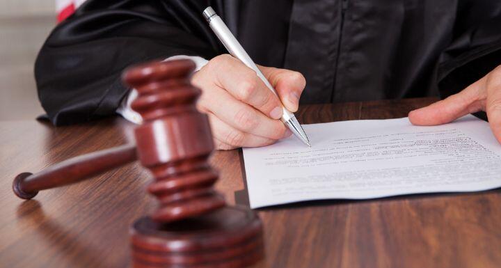Male Judge Writing On Paper