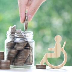 Man on wheelchair and coin money in the glass bottle