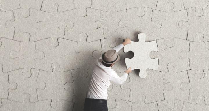 Man placing last puzzle piece