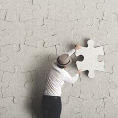 Man placing last puzzle piece
