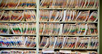 Shelves full of medical records and patient charts