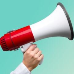 Hand holding red and white megaphone