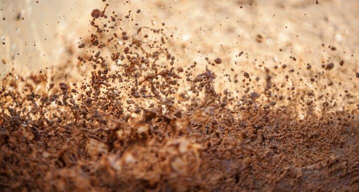 Body of muddy brown water caught mid-splash