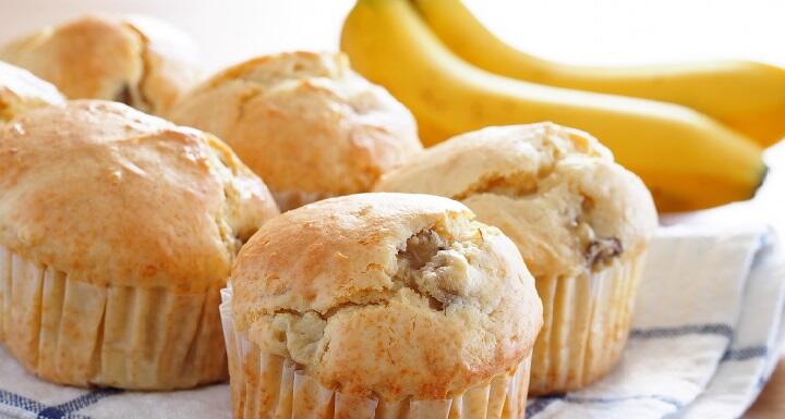 A selection of bananas and muffins on a kitchen towel