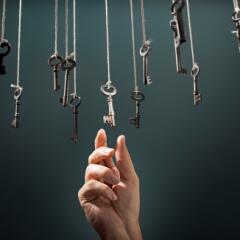 Hand reaching up to key