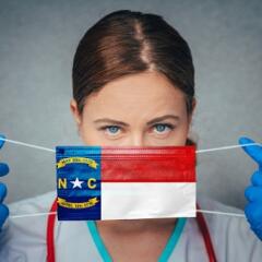 Woman Medical Professional putting on NC Flag Mask