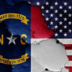 North Carolina and American flags painted onto cracked wall