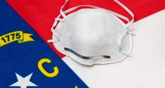 White Medical Mask on NC Flag