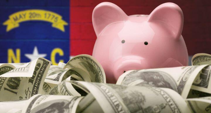 North Carolina Flag with Piggy Bank and Money