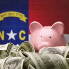 North Carolina Flag with Piggy Bank and Money