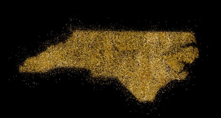 North Carolina shaped from gold glitter on a black background