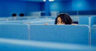 Office worker eavesdropping in cubicle