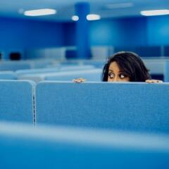 Office worker eavesdropping in cubicle