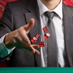 A gentleman in a suit rolling dice