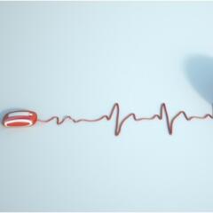 Red computer mouse with the cord formed into a heart beat 