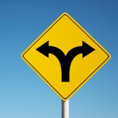 Road sign with arrows pointing in opposite directions