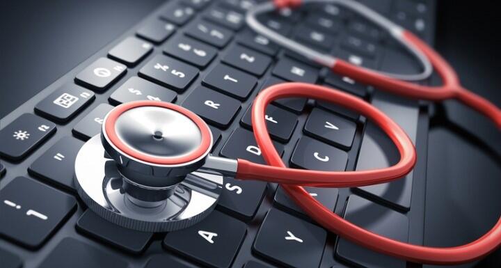 Orange Stethoscope on black keyboard