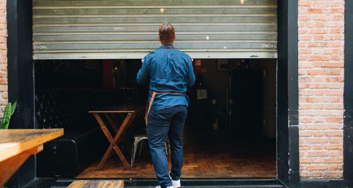 Owner man opening or closing his coffee shop