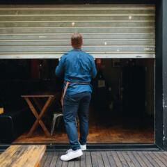 Owner man opening or closing his coffee shop