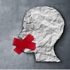 Person paper cut out with red tape over mouth