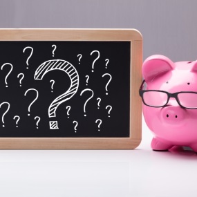 Piggy bank with glasses on chalkboard