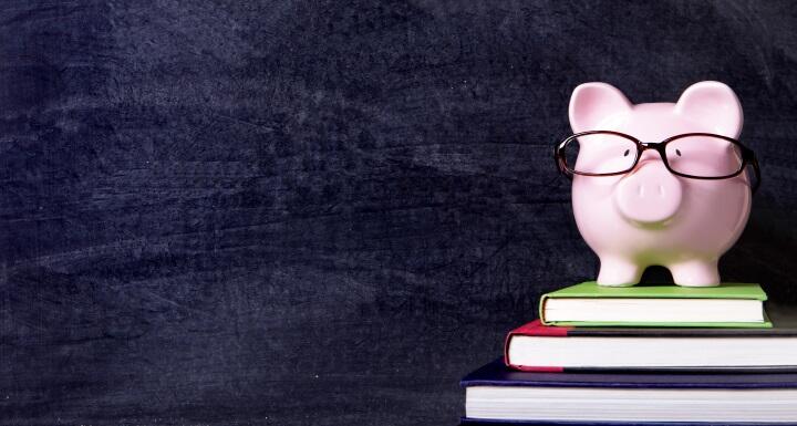 Piggybank with glasses and blackboard