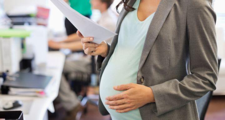 Pregnant businesswoman working in office