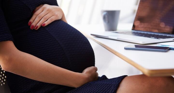 Pregnant woman working in office
