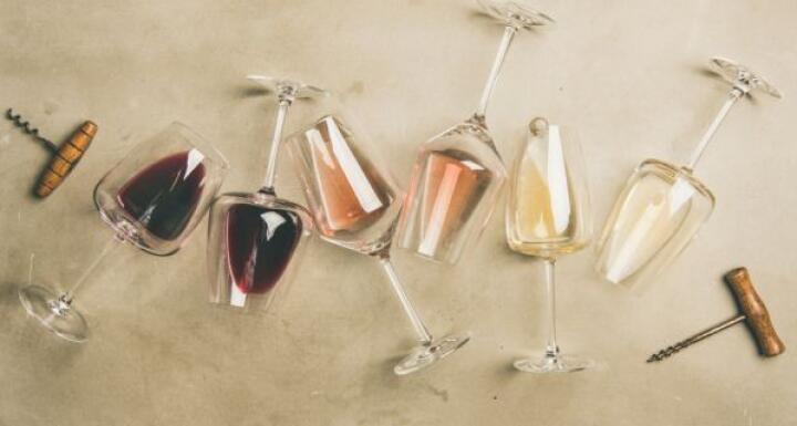 Red, rose and white wine in glasses and corkscrew
