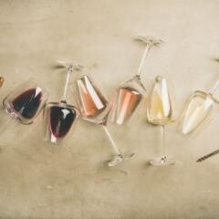 Red, rose and white wine in glasses and corkscrew