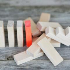 Red domino stops falling dominos