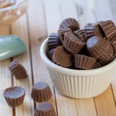 White bowl of Mini Reese Peanut Butter Cups overflowing
