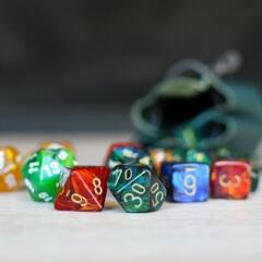 Colorful dice from various games spilled onto a table top
