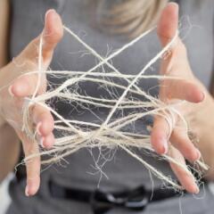 Woman unraveling a cat's cradle