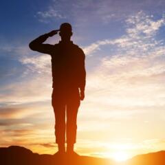 Silhouette of saluting soldier