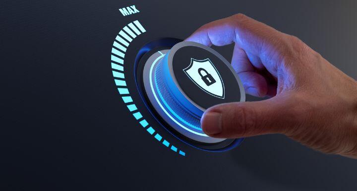 A hand moving dial with a shield icon on it. 