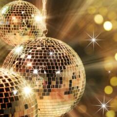 Shiny disco balls under yellow light