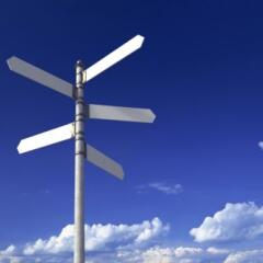 Signpost with three blank signs on sky backgrounds