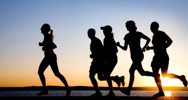 Silhouette of runners at beach