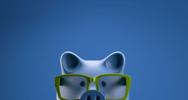 a piggy bank wearing green glasses
