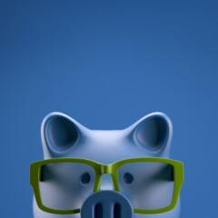 a piggy bank wearing green glasses