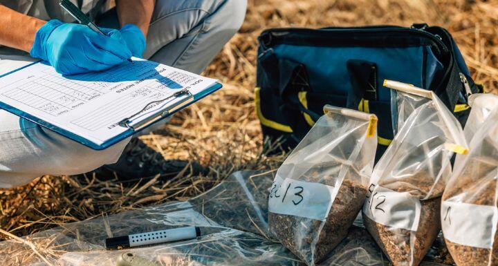 Soil Test. Female agronomist taking notes in the field.