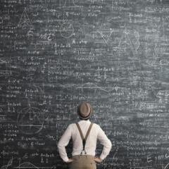 Man solving math problem on blackboard