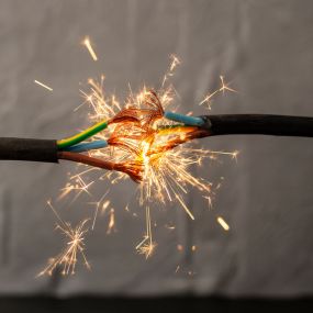 Sparks explosion between two electrical cords