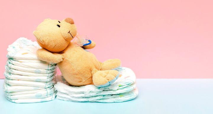Stack of diapers with cute teddy bear